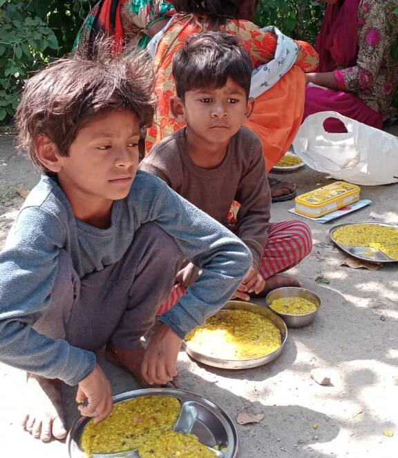 Children enjoying a meal served by Feeding Universe