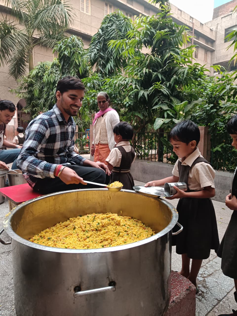 Feeding Universe volunteer serving food to children