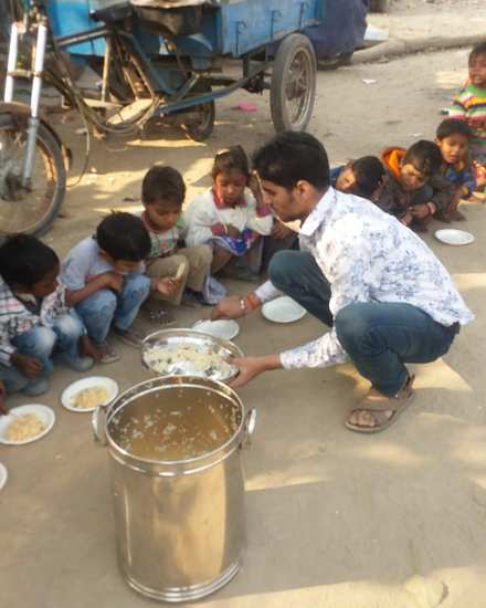 Founder Harpreet Singh serving a meal to children