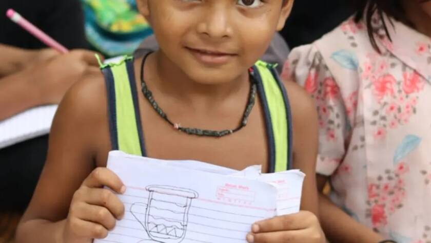 Children with notebooks and stationery from Feeding Universe
