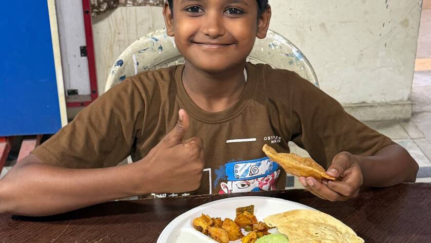 Children enjoying a meal served by Feeding Universe volunteers